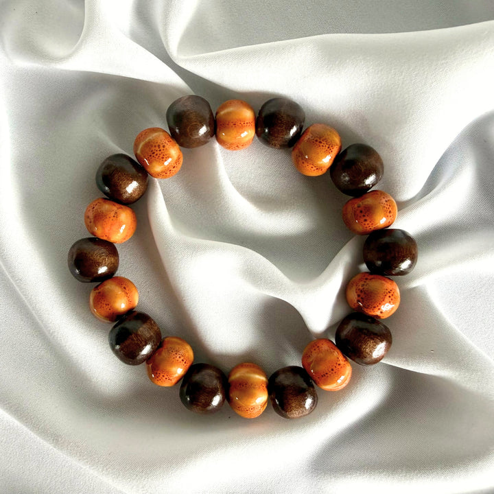 Ceramic and wood beaded bracelet in light and dark brown on white background