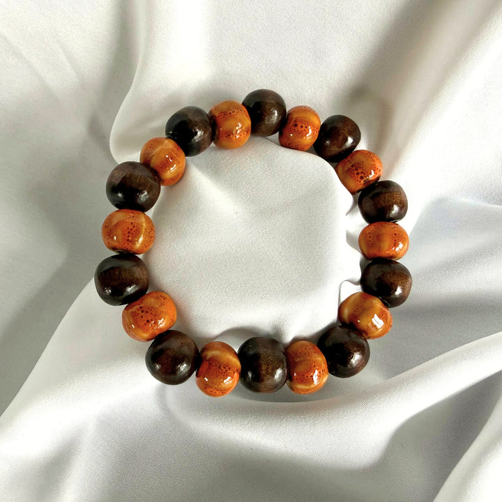 Full view of ceramic and wood beaded bracelet in light and dark brown