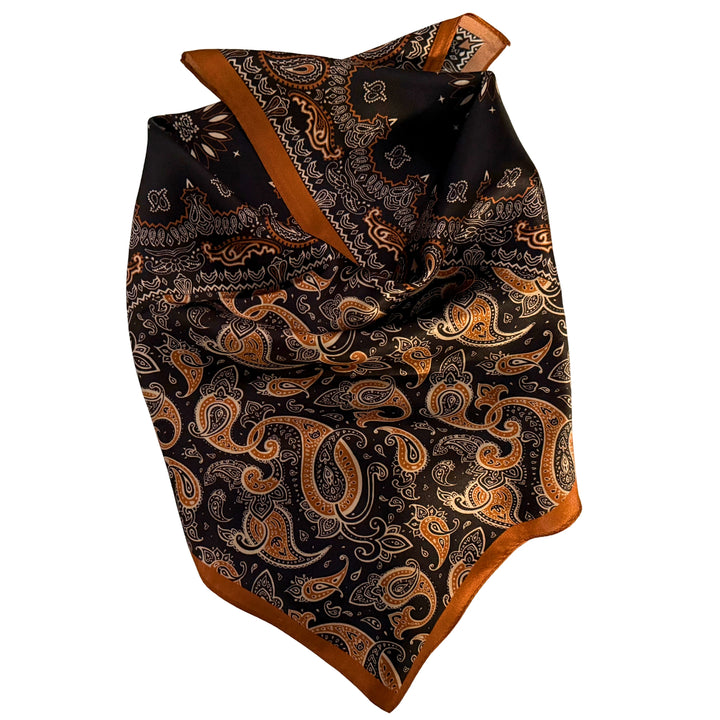 Black and copper silk scarf neatly folded showing the detailed pattern.