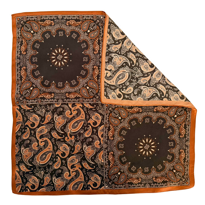 Black and copper silk scarf with folded corner showing reverse side and one-sided print.