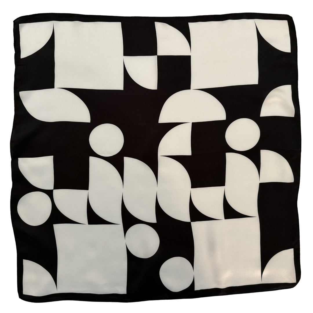 Black and ivory silk scarf with circles and squares shown in full top view.