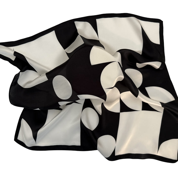 Black and ivory silk scarf loosely spread to show overall geometric design.