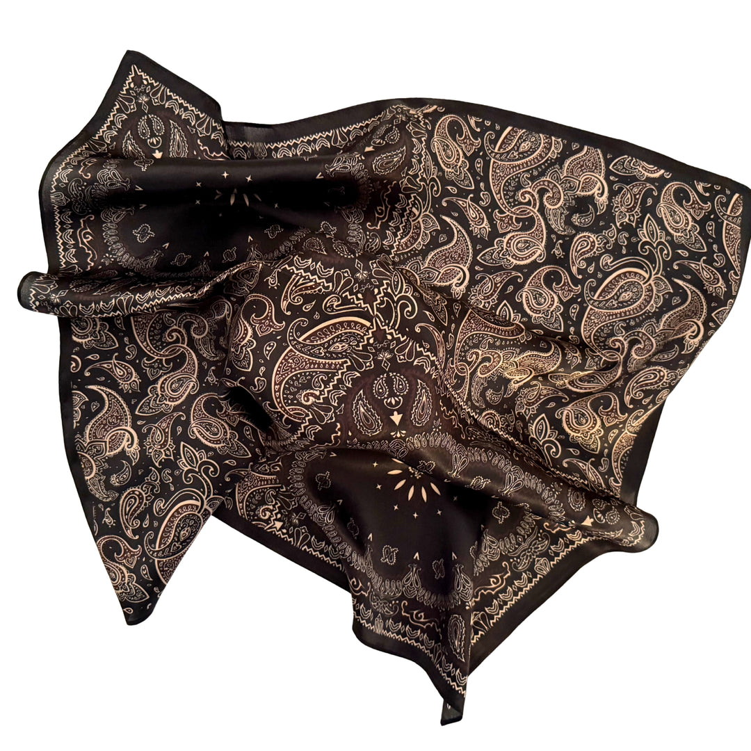 Floral paisley silk scarf loosely spread to display the full design and black border.