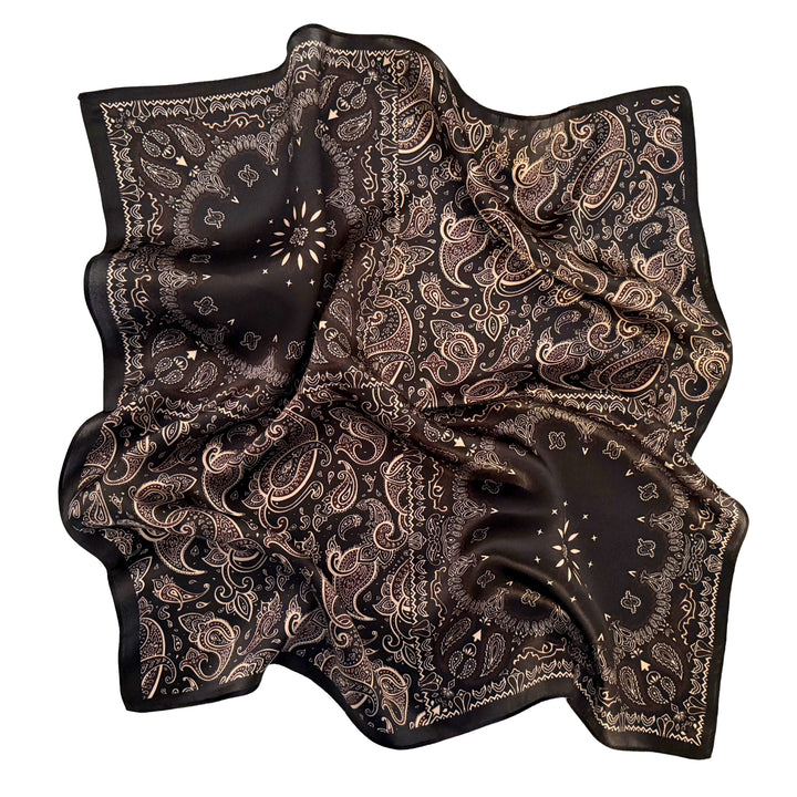 Floral paisley silk scarf softly laid out in a relaxed arrangement.