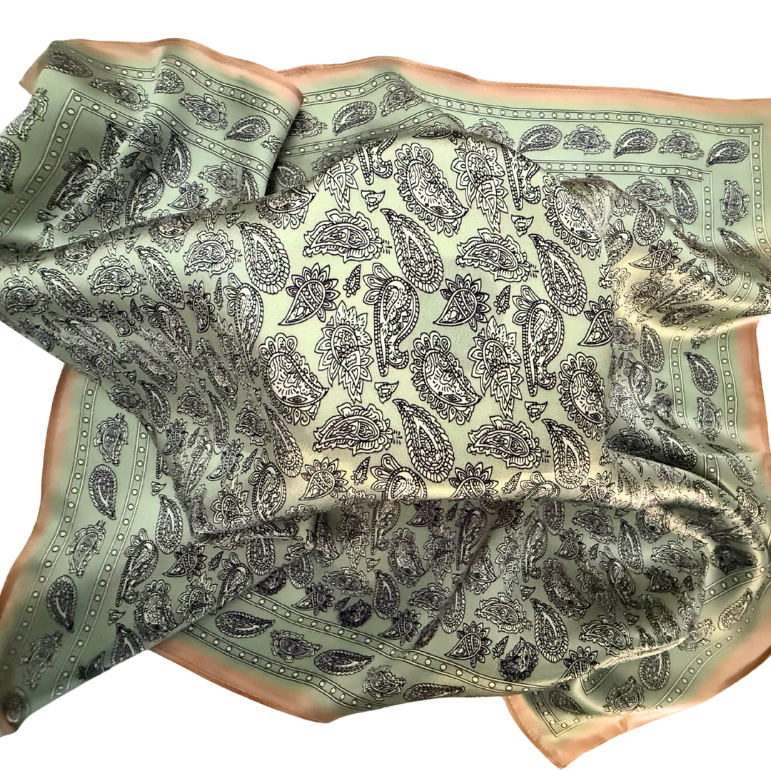 Paisley silk scarf loosely spread to display the full design and copper border.