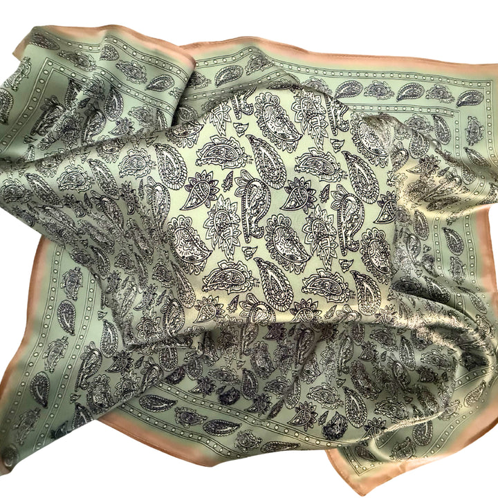 Paisley silk scarf loosely spread to display the full design and copper border.