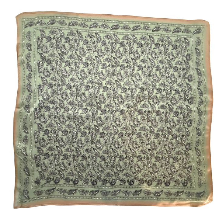 Black, white and green paisley silk scarf with copper border shown in full top view.