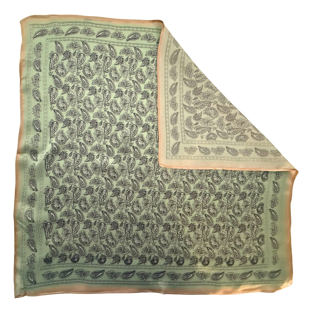 Paisley silk scarf with folded corner showing reverse side and one-sided print.