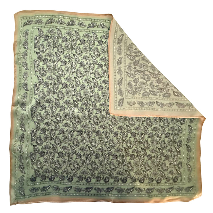 Paisley silk scarf with folded corner showing reverse side and one-sided print.