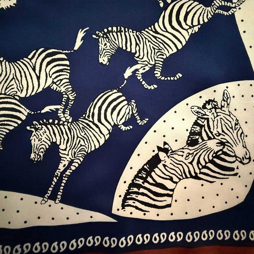 Close-up of blue and white zebra print on silk fabric.