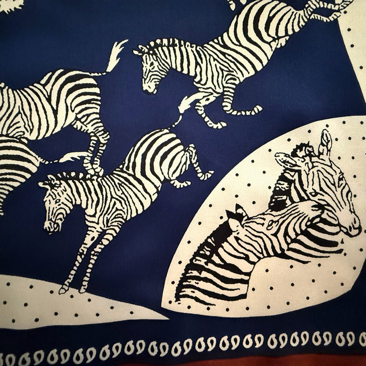 Close-up of blue and white zebra print on silk fabric.