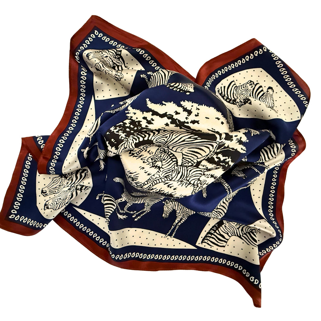 Blue and white zebra silk scarf loosely spread to display the full design and copper border.