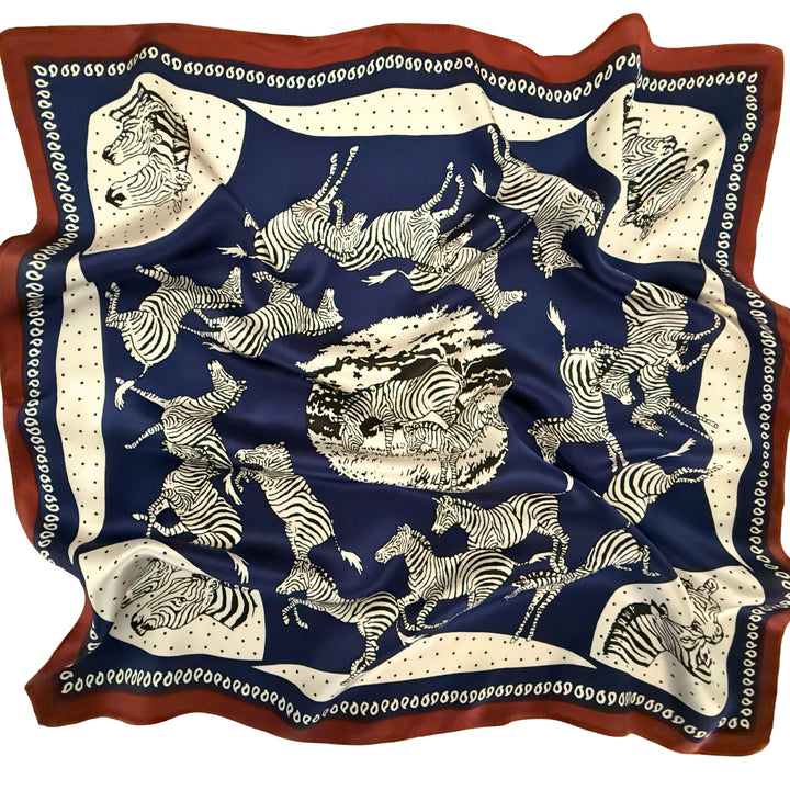 Blue and white zebra silk scarf softly laid out in a relaxed arrangement.