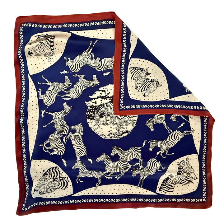 Blue and white zebra silk scarf with folded corner showing reverse side and one-sided print.