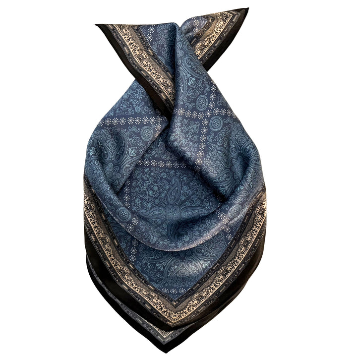 Blue diamond pattern silk scarf neatly folded showing the pattern and black border.