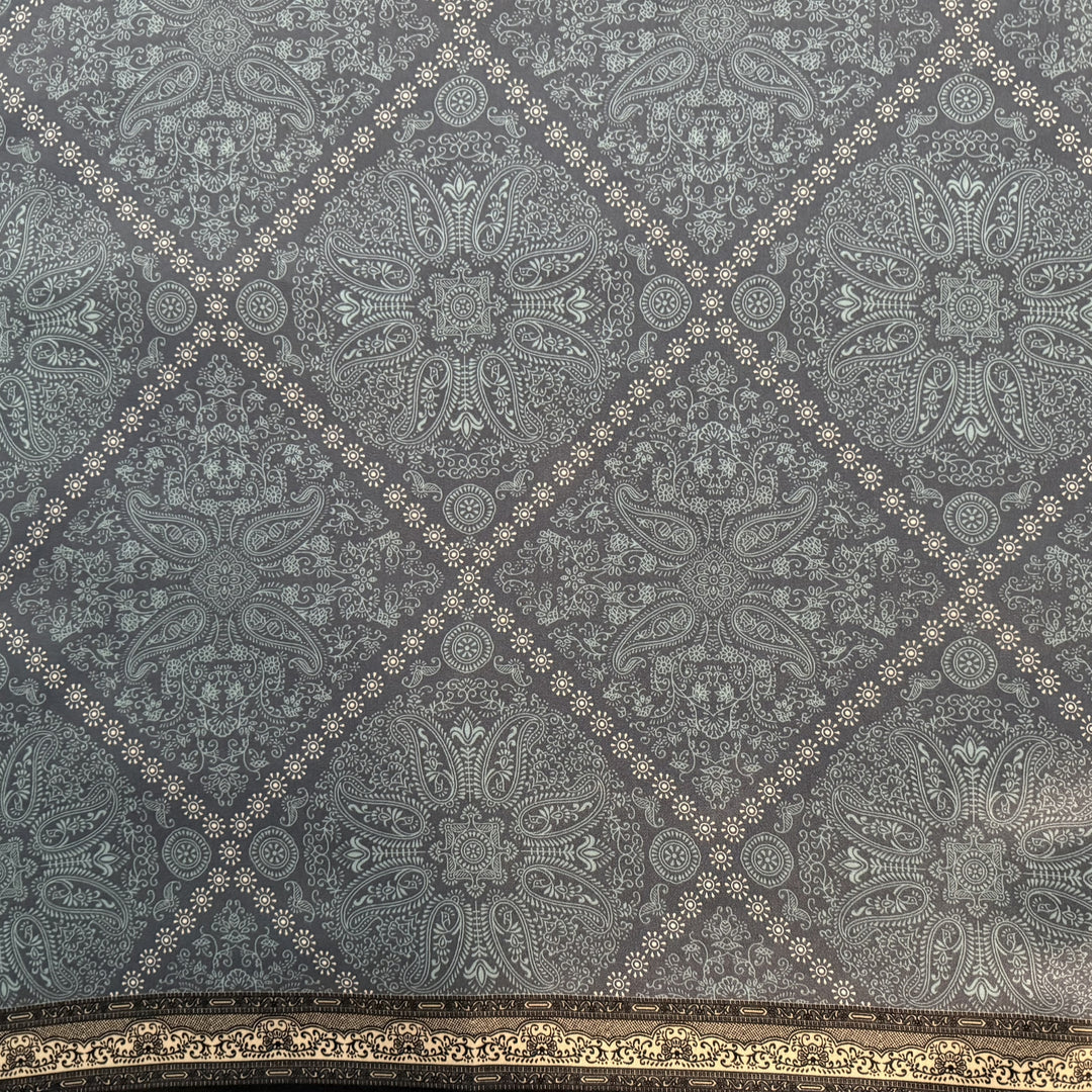 Close-up of white diamond pattern on blue silk fabric.
