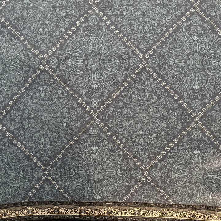 Close-up of white diamond pattern on blue silk fabric.