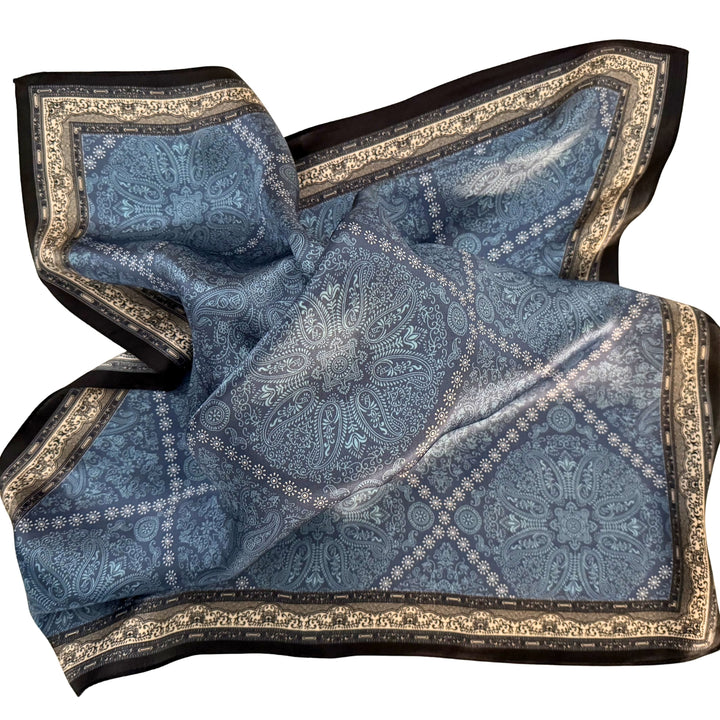 Blue diamond pattern silk scarf loosely spread to display the full design.