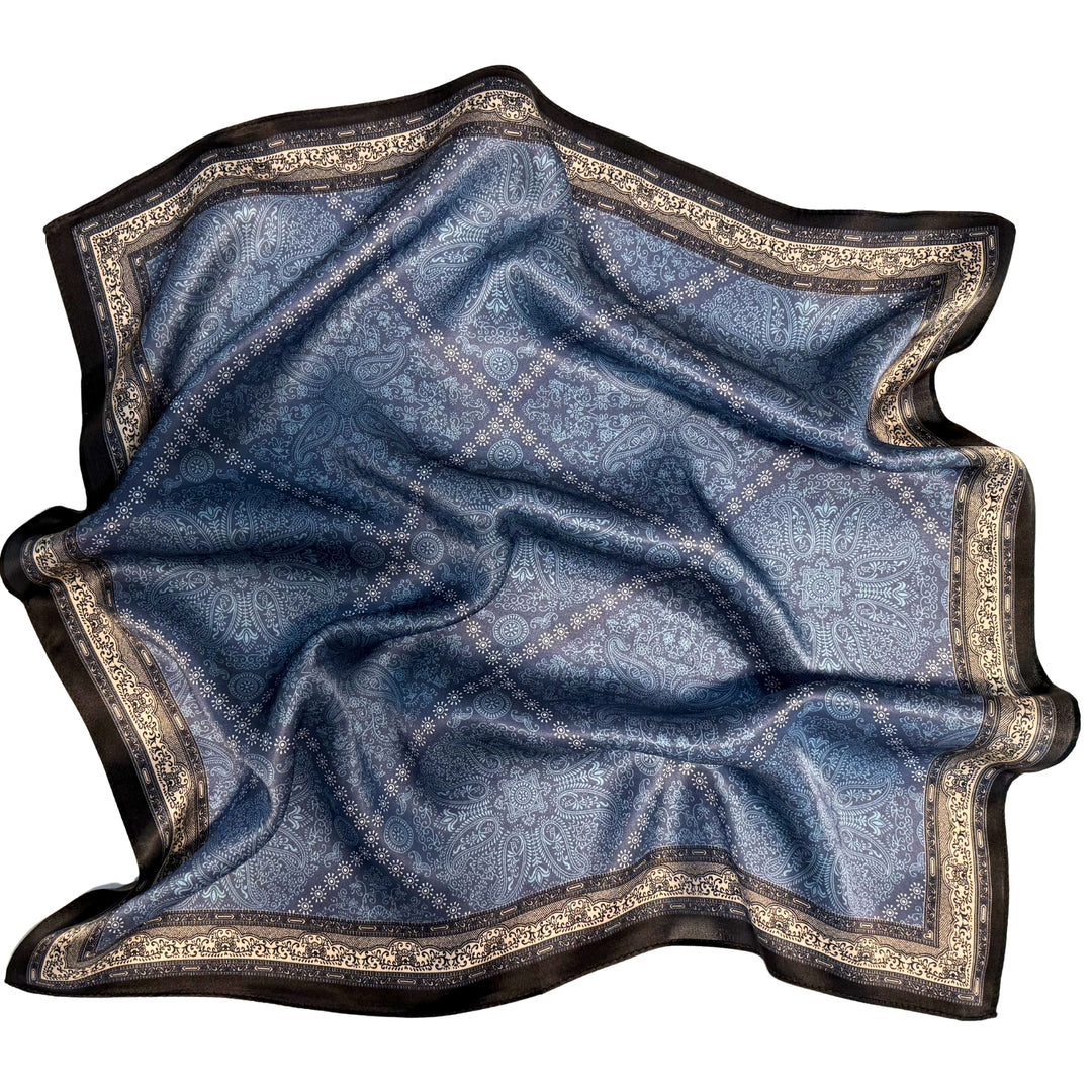 Blue diamond pattern silk scarf softly laid out in a relaxed arrangement.