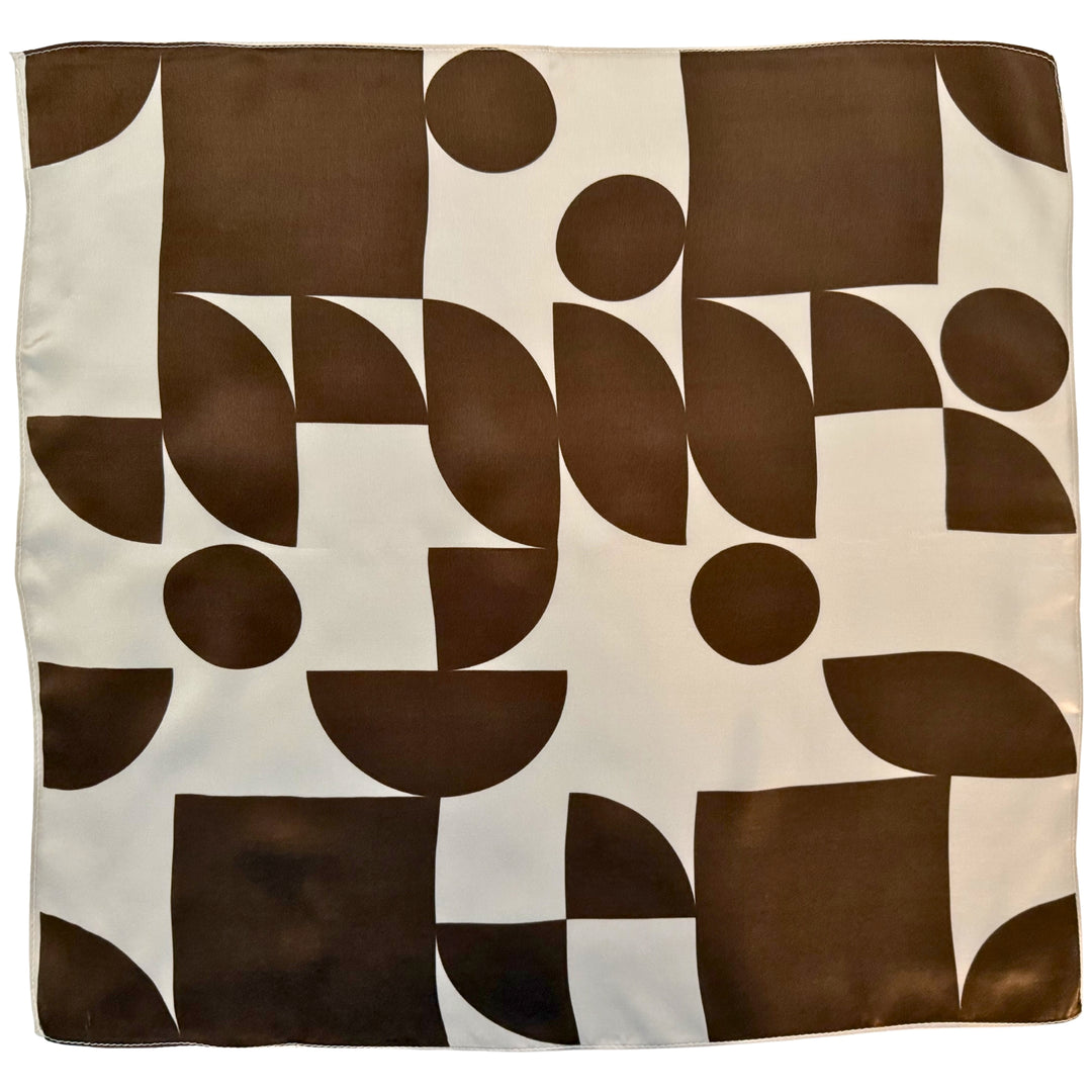 Brown geometric silk scarf on ivory background shown in full top view.