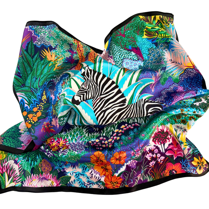 Colourful zebra silk scarf loosely spread to display the full artwork and black border.