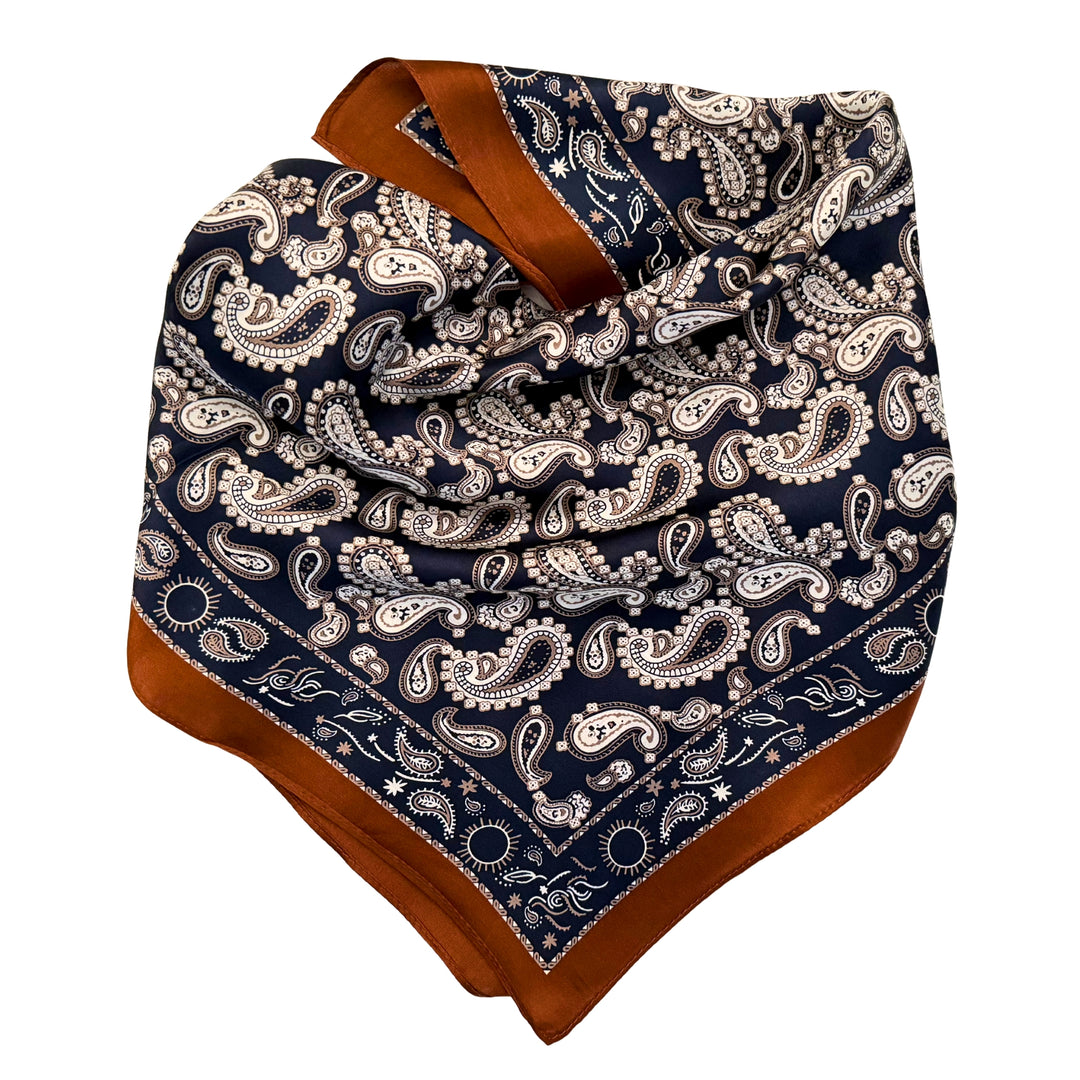 Dark blue paisley silk scarf neatly folded showing the detailed pattern.