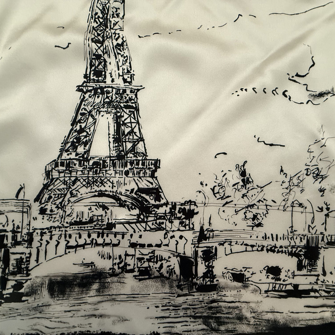 Close-up of the Eiffel Tower and Paris-inspired illustration on silk.