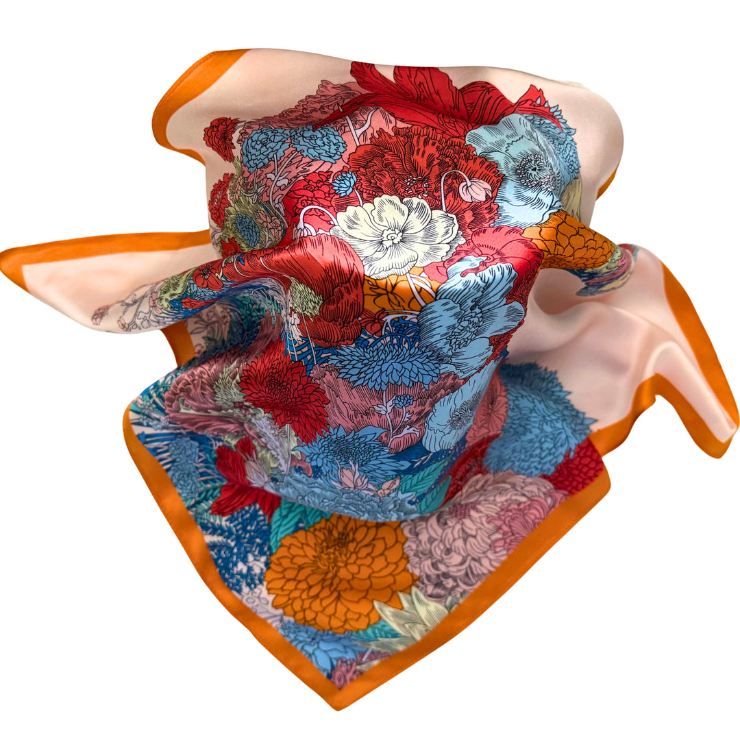Floral horse silk scarf loosely spread to display the full design and orange border.