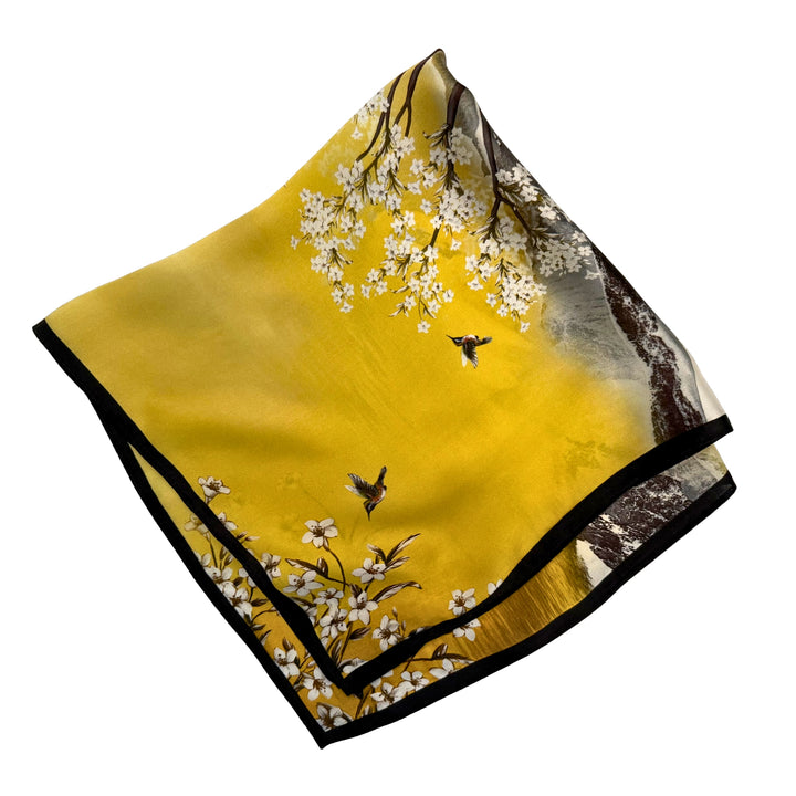 Mulberry silk scarf folded into a square showing parts of the landscape print and black border edges.