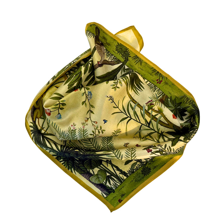 Green botanical silk scarf neatly folded to highlight the nature-inspired design.