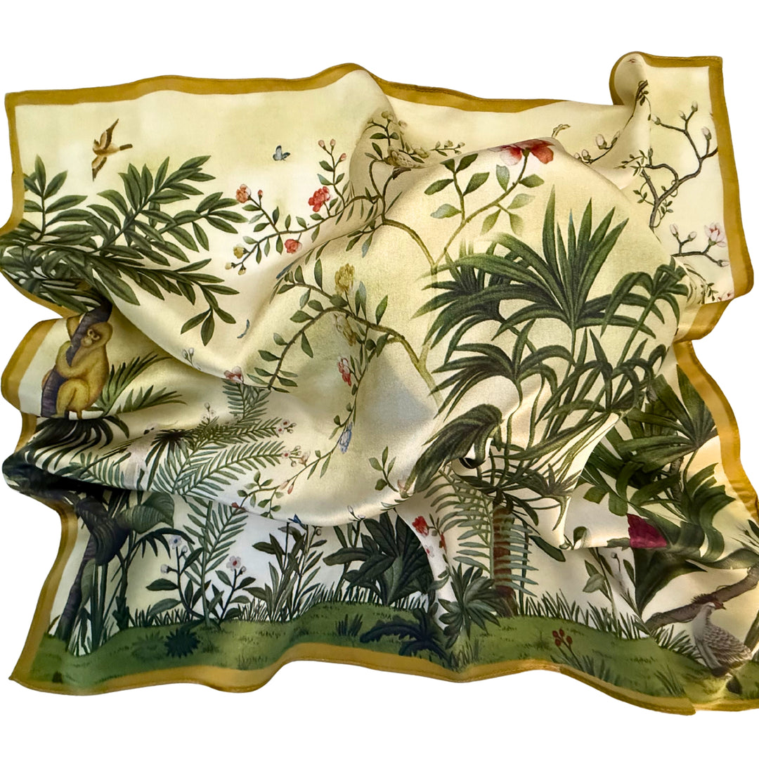 Green botanical silk scarf softly laid out in a relaxed arrangement.