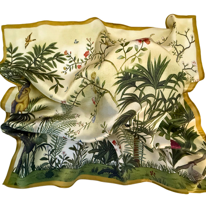 Green botanical silk scarf softly laid out in a relaxed arrangement.