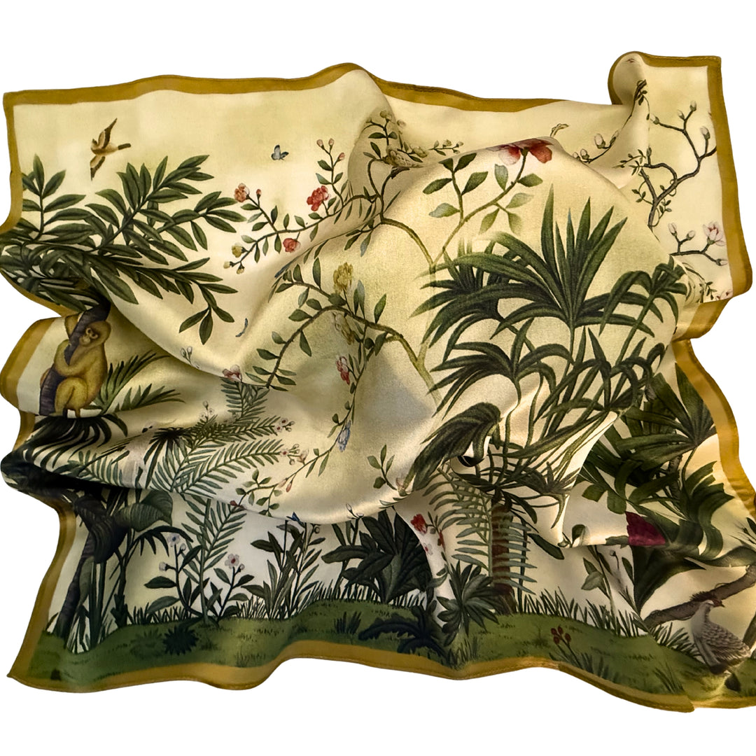 Green botanical silk scarf loosely spread to display the full botanical artwork.