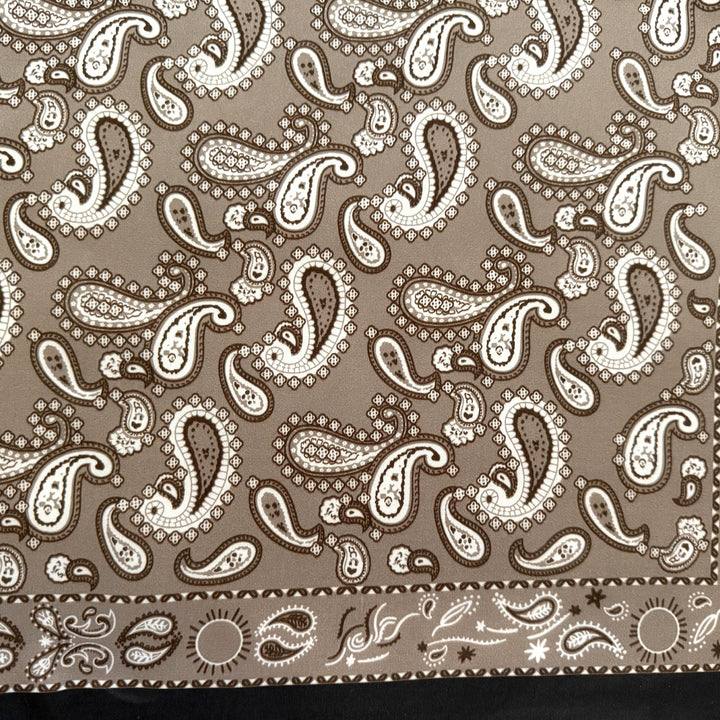 Close-up of the grey beige paisley pattern on mulberry silk.