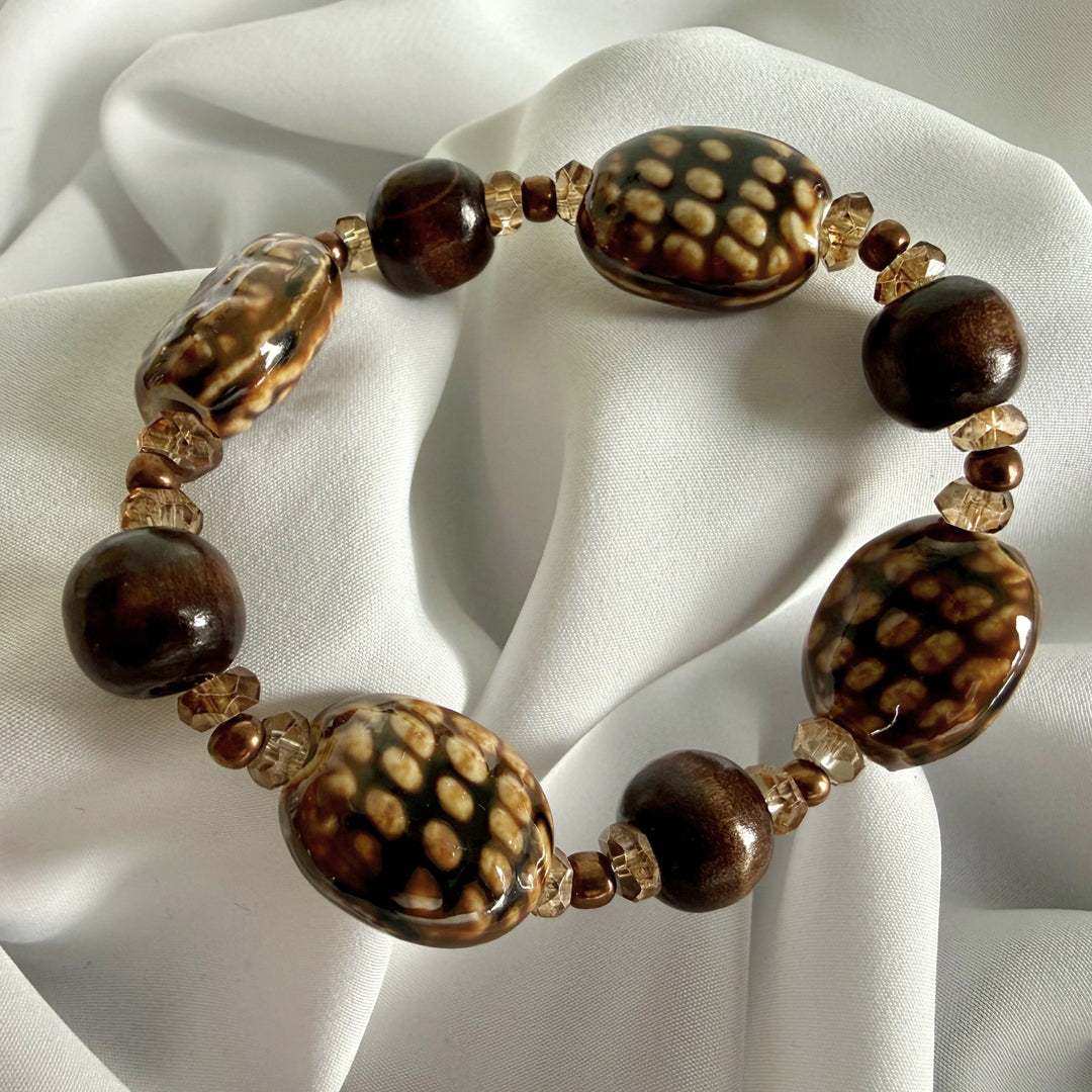 Full view of a handcrafted bracelet with ceramic, wood, glass, and acrylic beads.