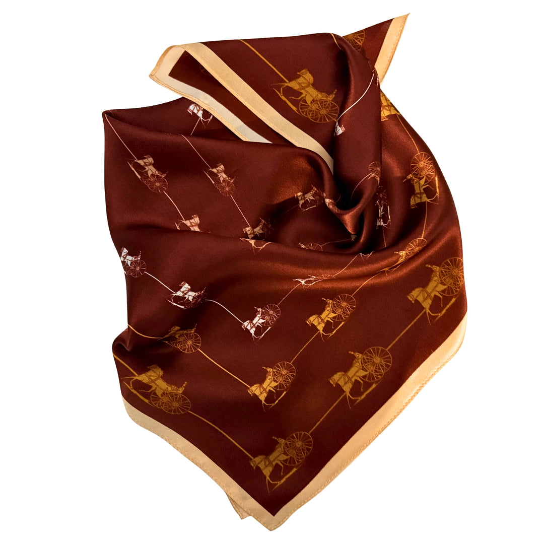 Horse and carriage silk scarf neatly folded showing the framed square design.