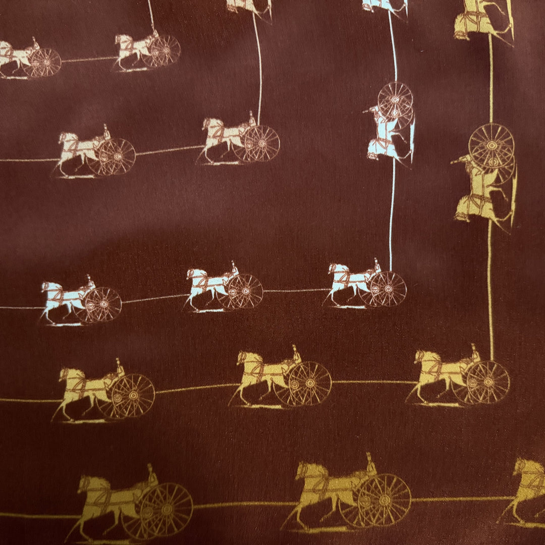 Close-up of framed horse and carriage motifs in mustard, white and beige tones.
