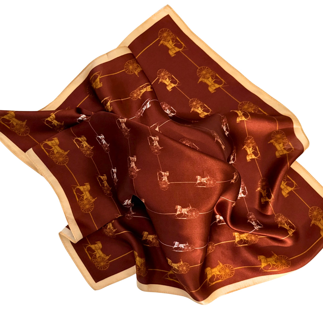 Horse and carriage silk scarf loosely spread to display the full framed pattern and beige border.