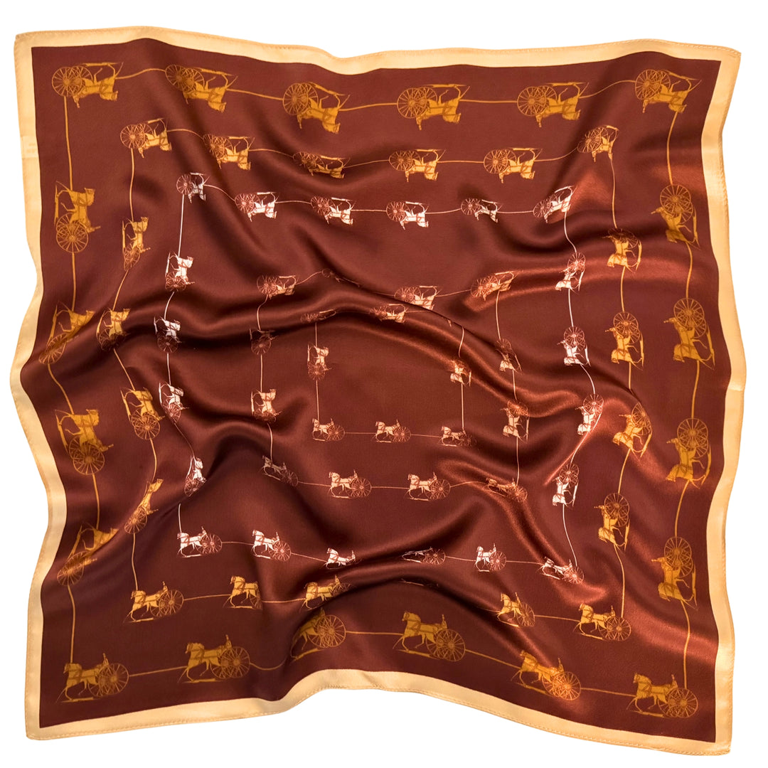 Horse and carriage silk scarf softly laid out in a relaxed arrangement.