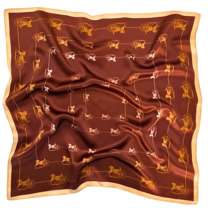 Horse and carriage silk scarf softly laid out in a relaxed arrangement.