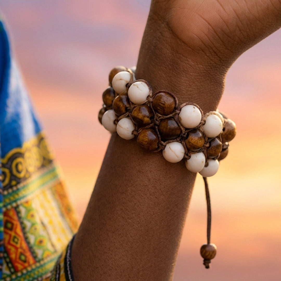 Close-up of a handcrafted howlite macramé bracelet worn on a woman’s wrist showing bead and knot details.