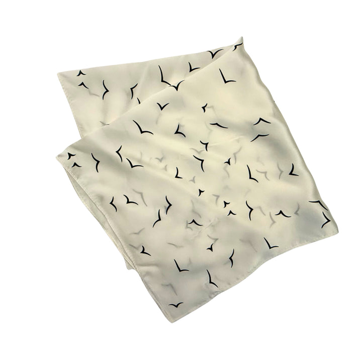 Ivory silk scarf folded into a square layout showing different angles of the pattern.