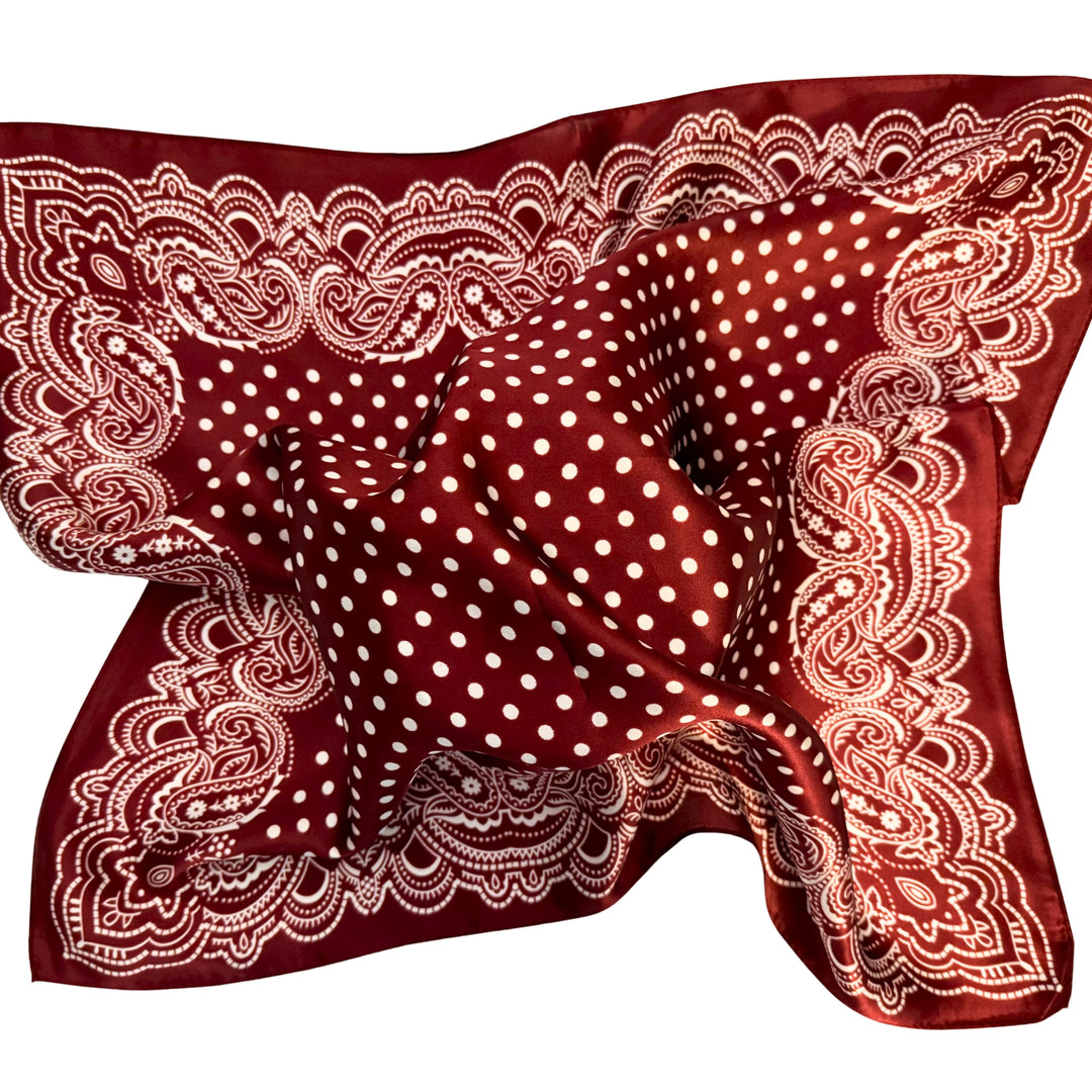 Maroon paisley silk scarf loosely spread to display the full pattern.