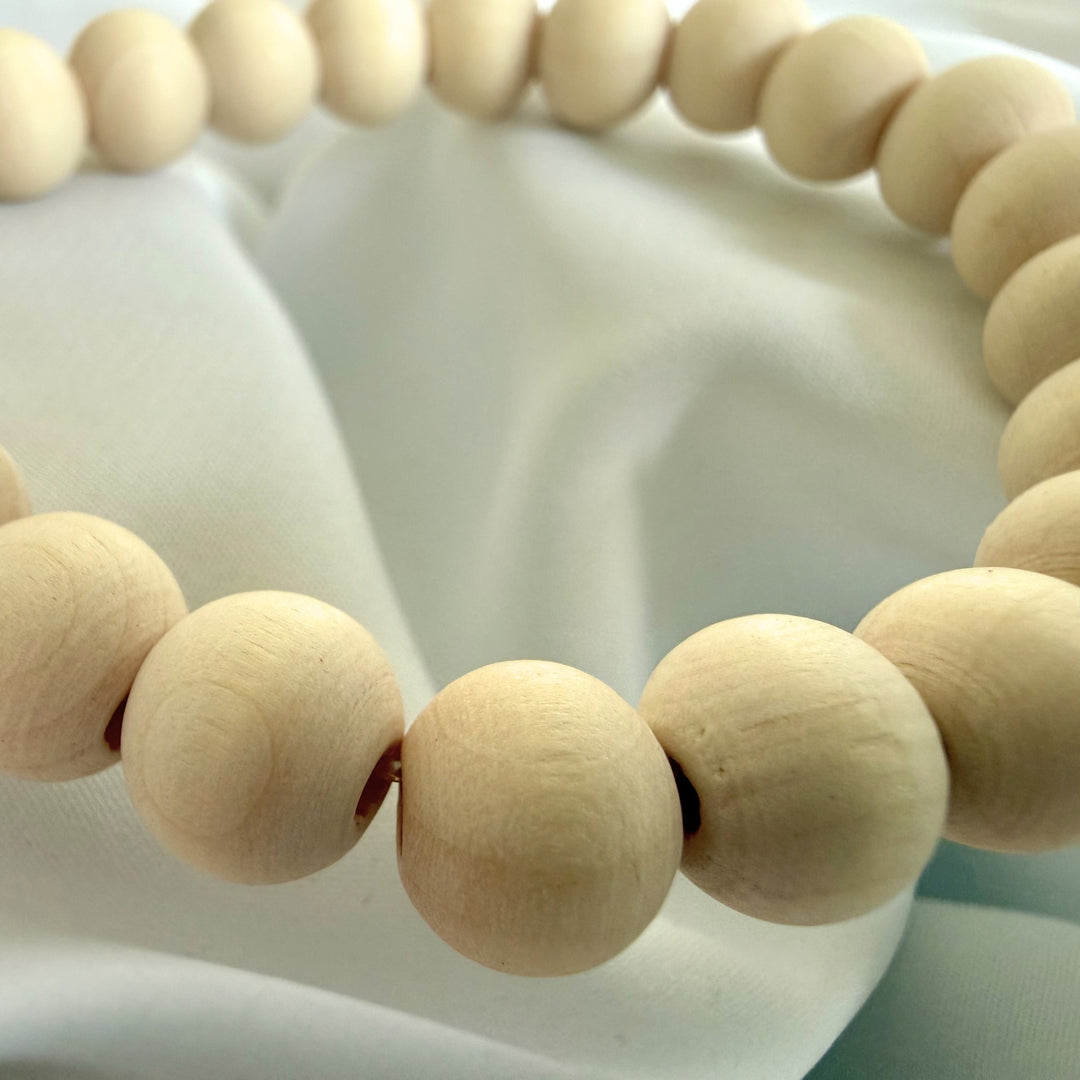 Close-up of natural wood beads showing organic grain and texture on a handcrafted bracelet.
