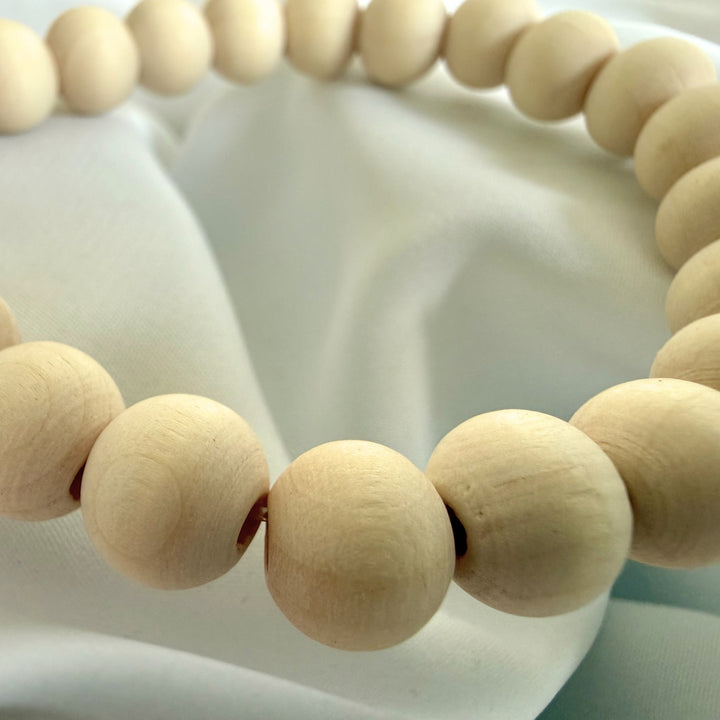 Close-up of natural wood beads showing organic grain and texture on a handcrafted bracelet.