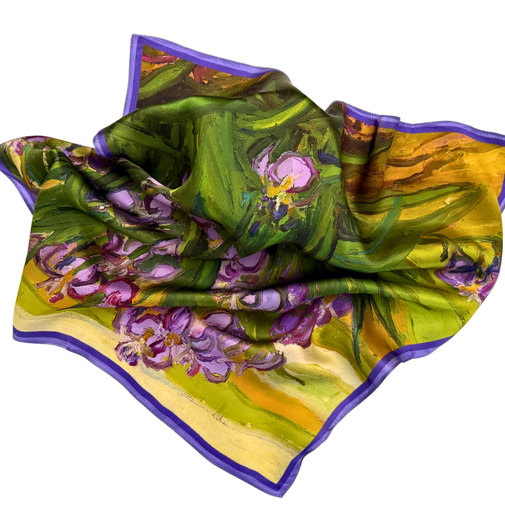 Purple floral silk scarf loosely spread to display the full floral artwork.