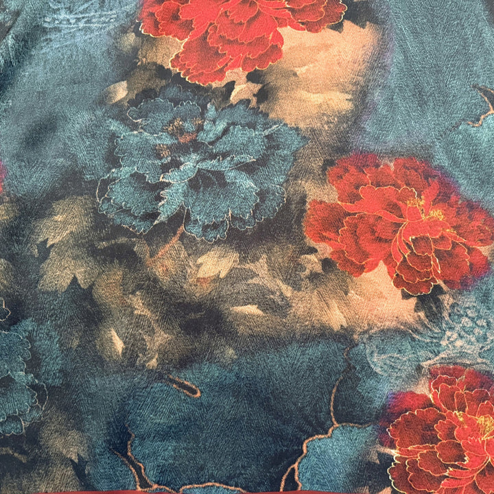 Close-up of large red and blue floral print on silk fabric.