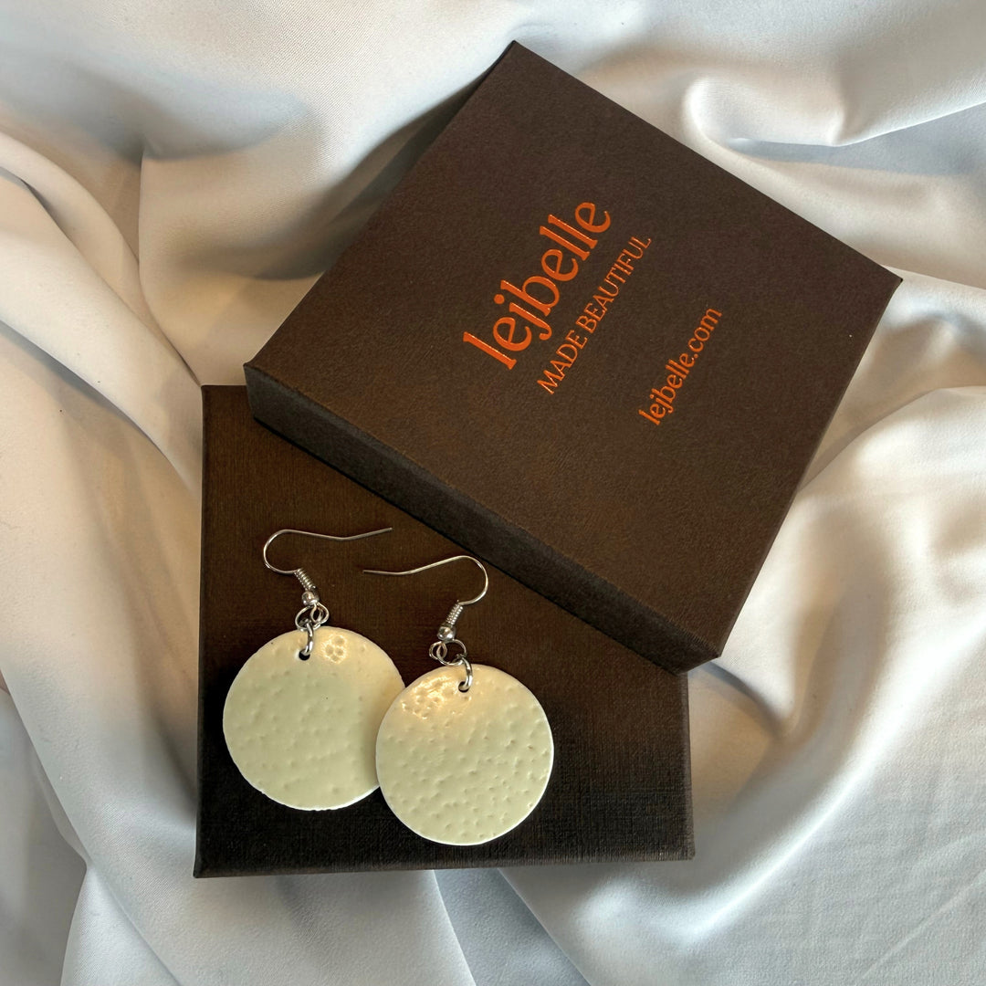 Handcrafted round ostrich eggshell drop earrings displayed side by side in a branded gift box with silver-tone hooks.