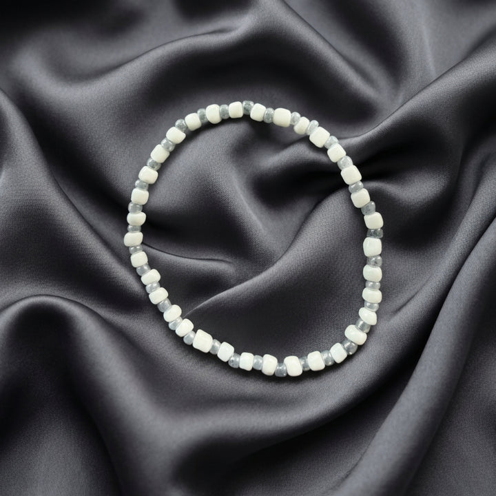 Full view of a handcrafted bracelet combining white and grey beads in a soft neutral colour palette.