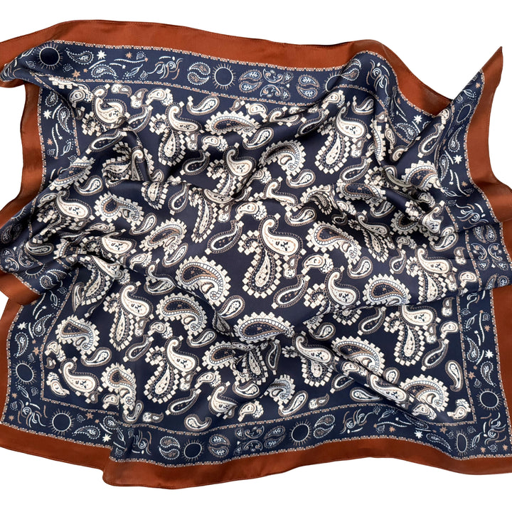 Paisley silk scarf loosely spread to display the full design and copper edge.